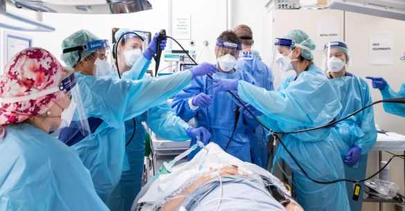 Surgical team working with a robot