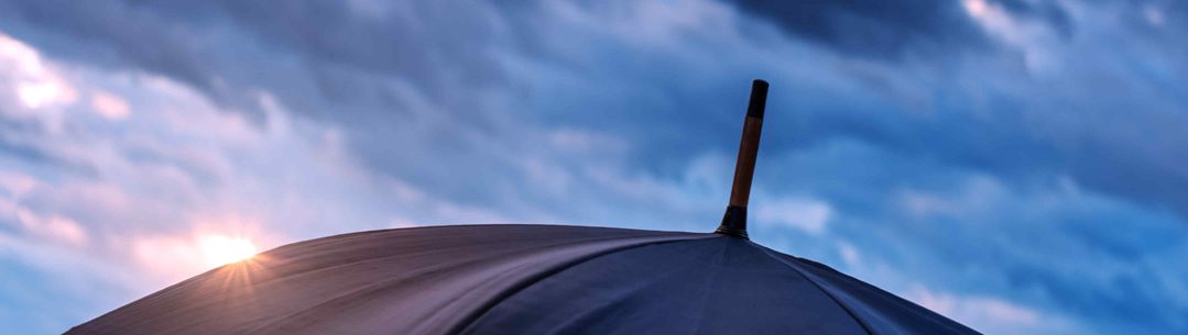 Umbrella and cloudy sky closeup