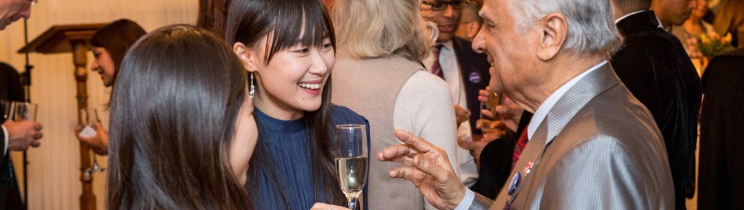 Alumni chatting at an event in the House of Lords