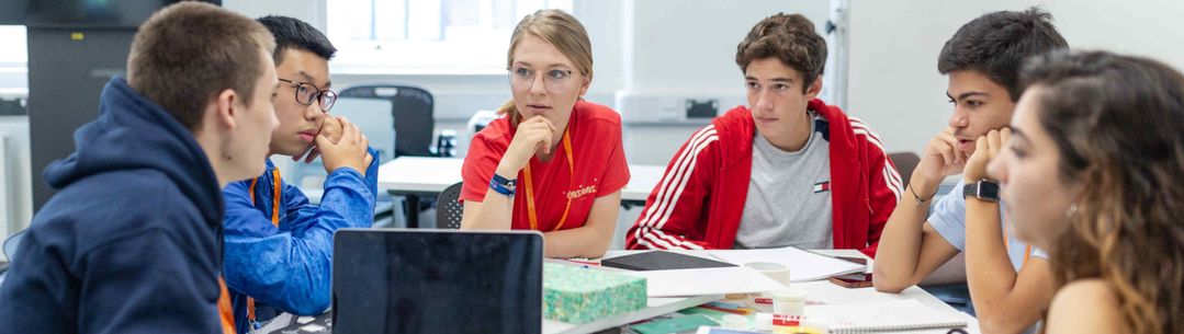 Student around a table planning a project