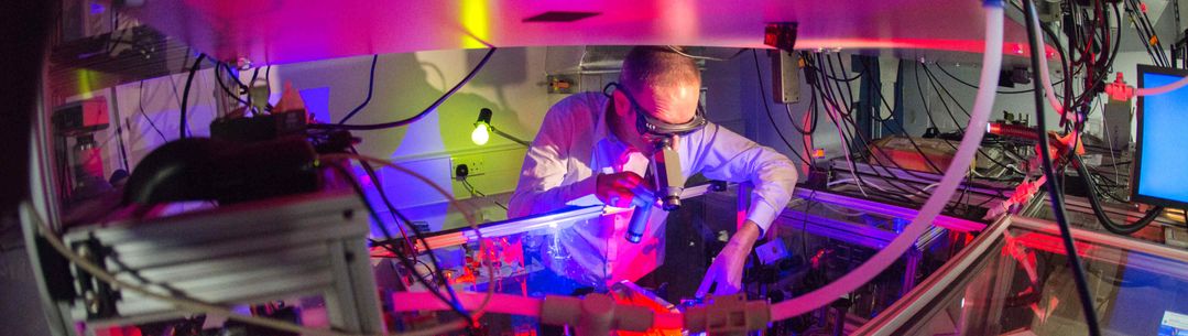 A scientist working with lasers