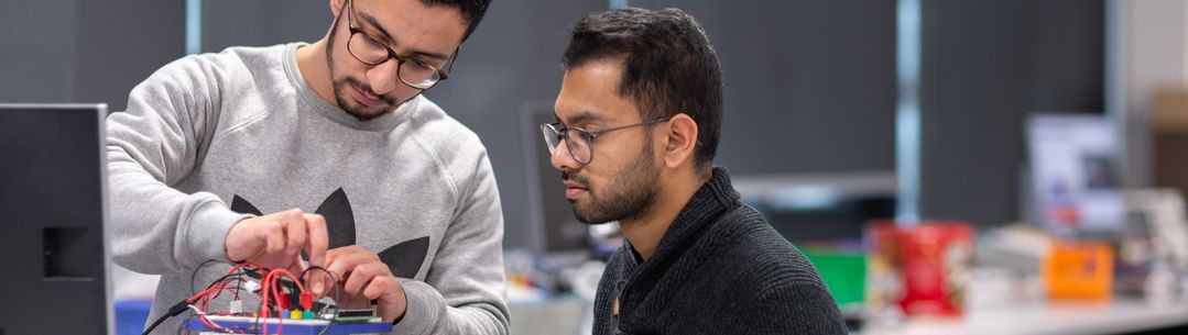 two students building a robot