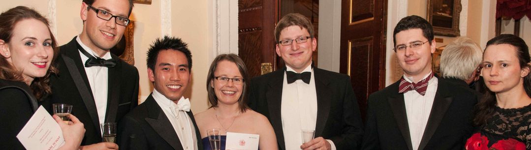 Group photo of alumni at a black tie event