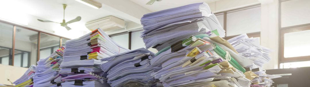Piles of documents on a desk