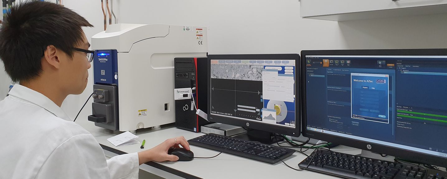 Student observing the microstructure of cementitious materials.