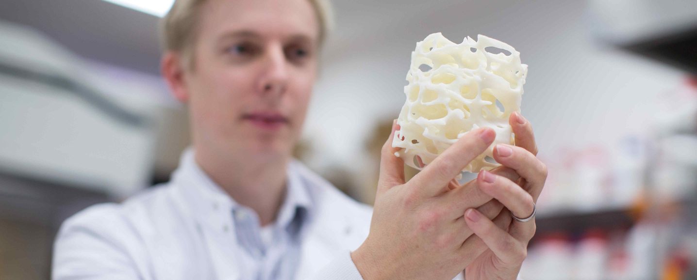 An image of Julian Jones holding the first 3D porous scaffold made from bioactive glass