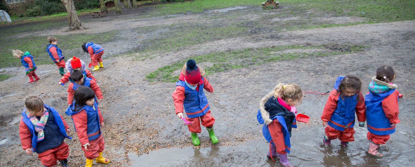 Children exploring the Secret Garden behind Early Years