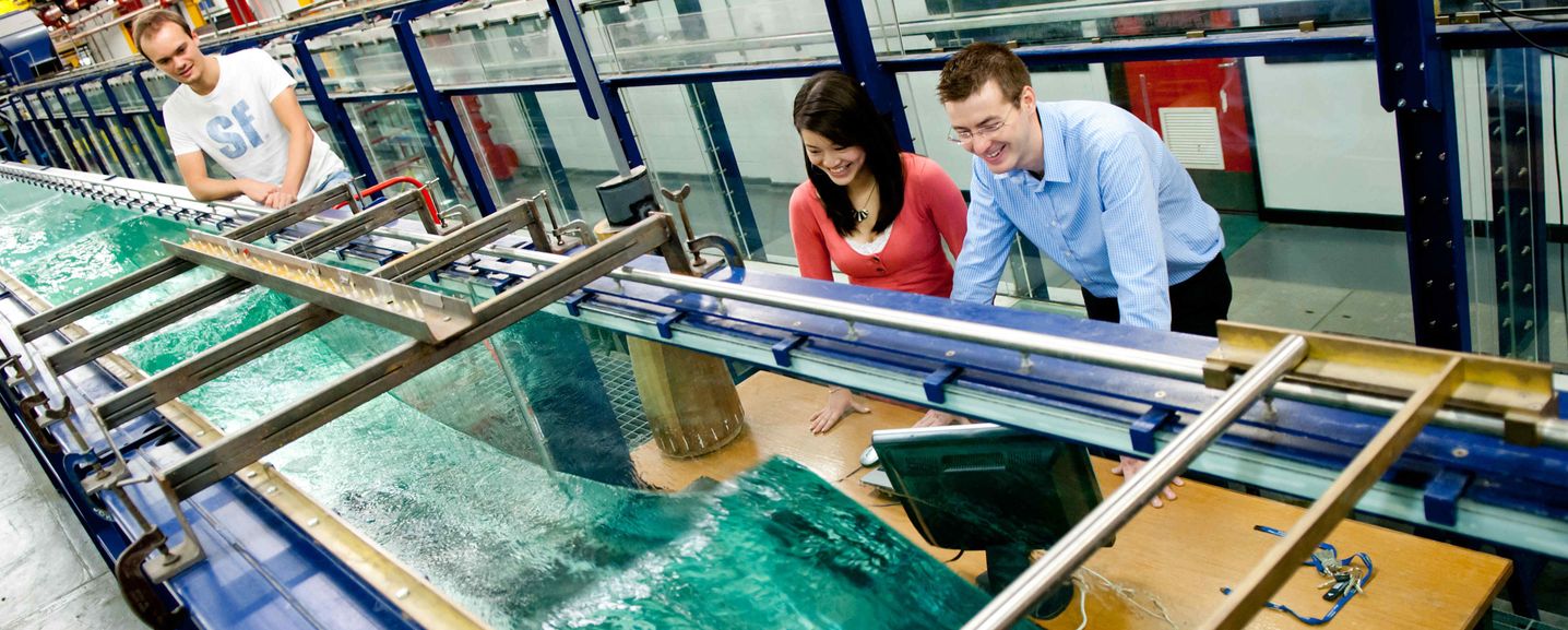 Imperial fluid mechanics staff and researchers observing steep water waves in the Hydrodynamics Research Laboratory.