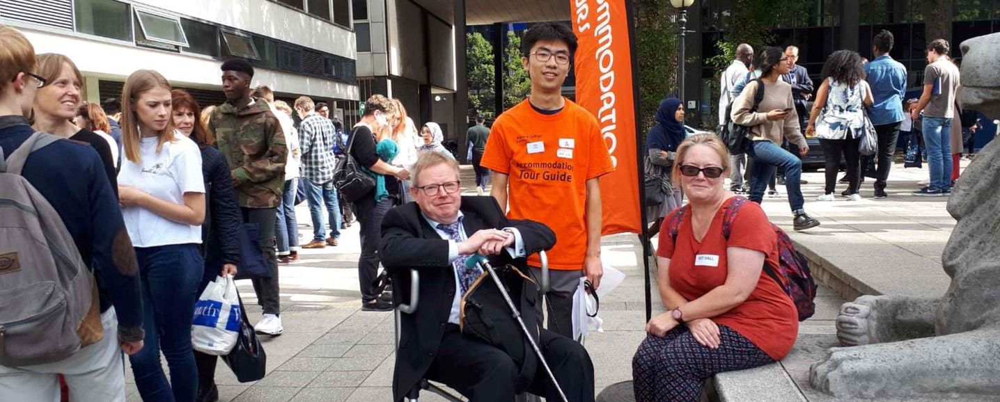 Tour Guide assisting wheelchair user