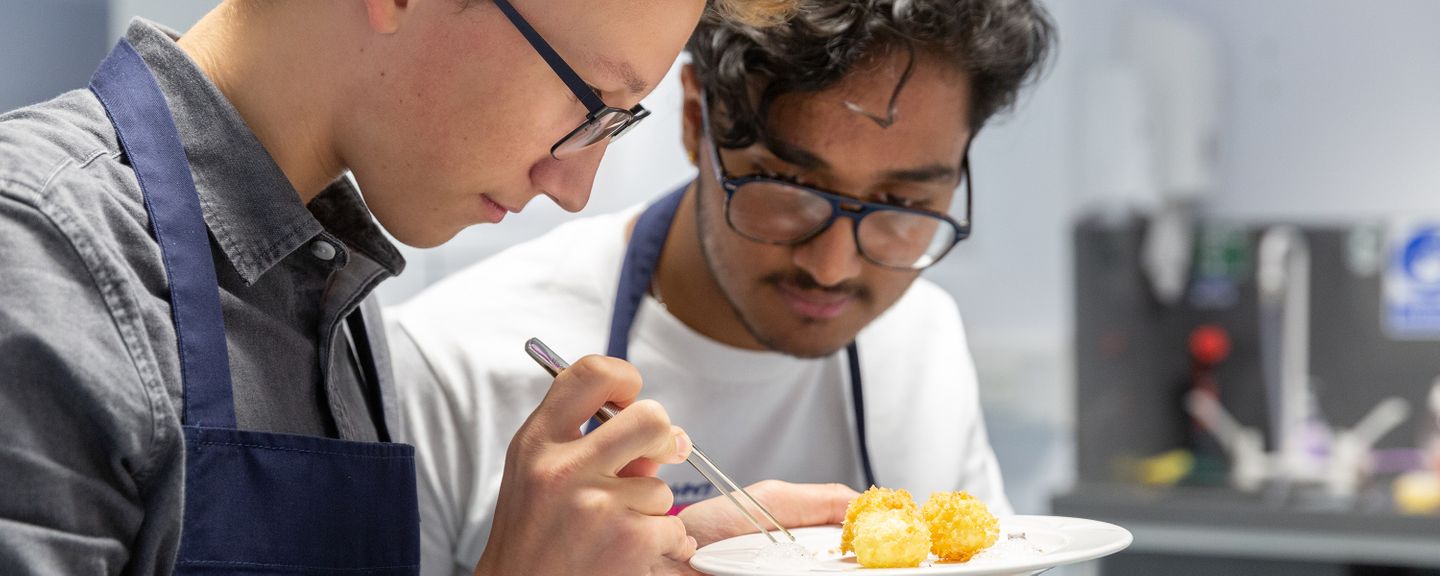 Two students in Chemical Kitchen investigating egg yolks