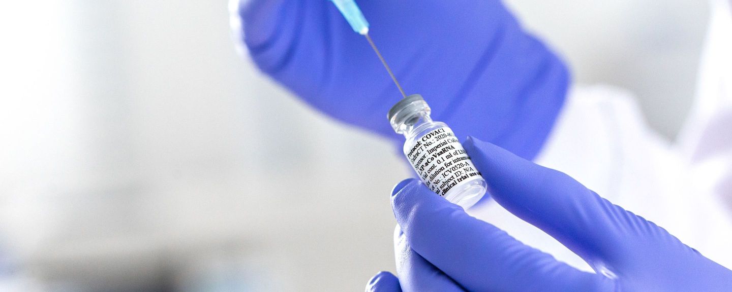 A scientist at Imperial College London draws the coronavirus vaccine into a syringe