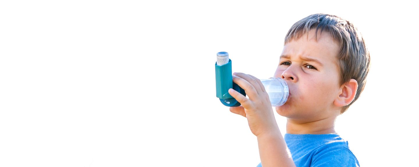 child with asthma using inhaler