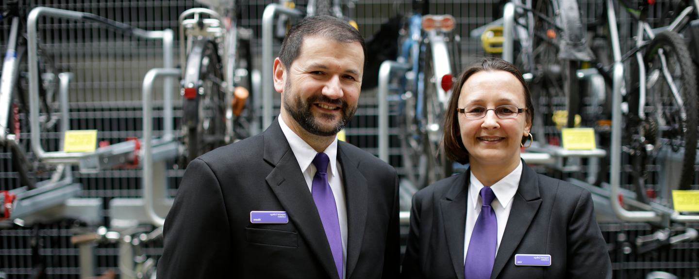 male and female community safety officers standing by bike rack