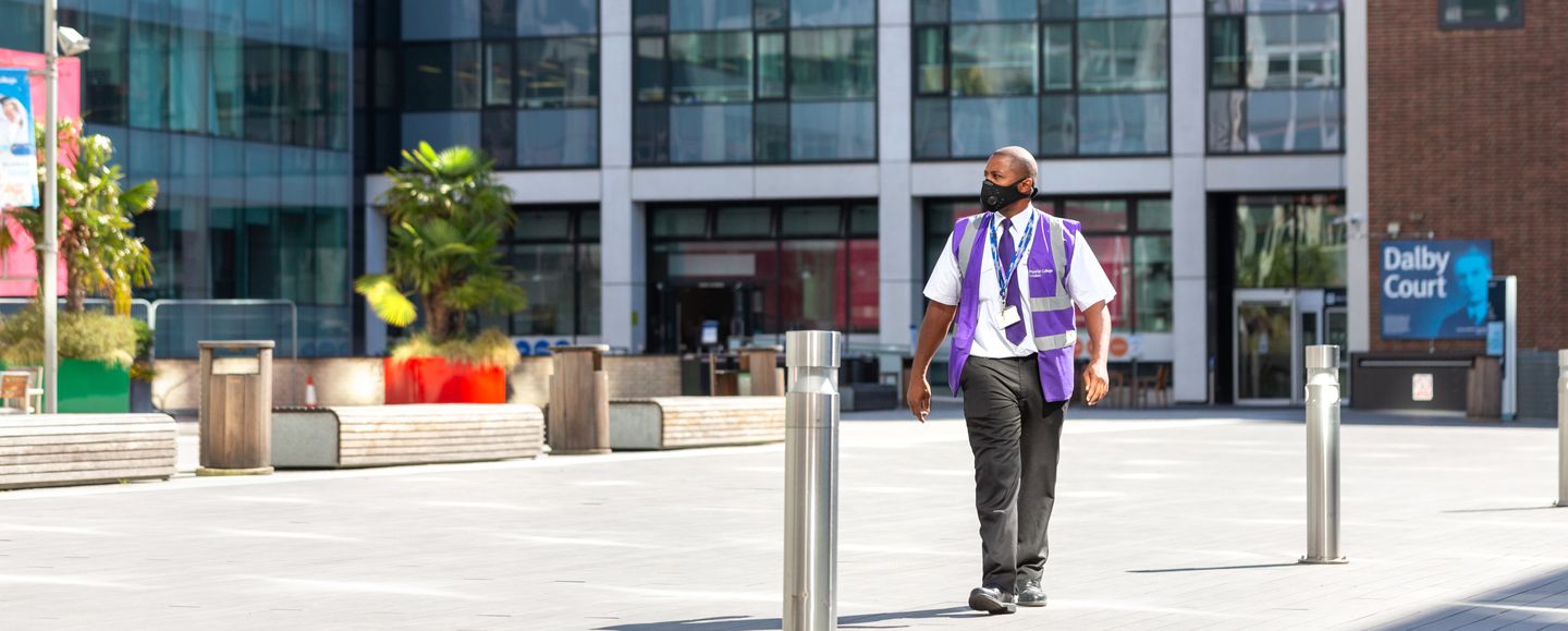 Security guard walking across Dalby Court