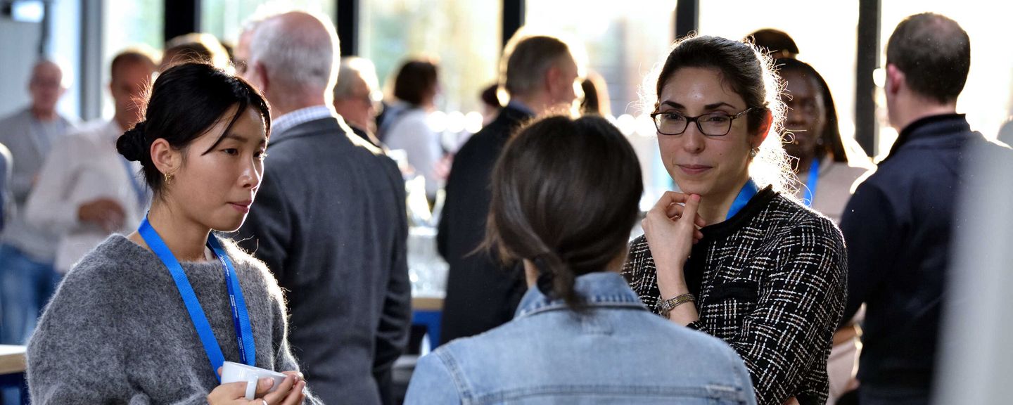 The image show researchers chatting during the launch event of the George Institute for Global Health at Imperial College London, 2022.