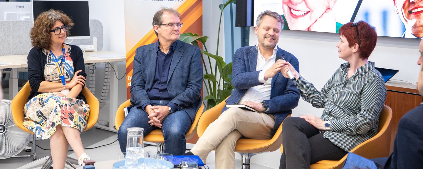 A discussion panel sat in front of a screen