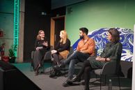 4 panellists on stage at an event at COP26