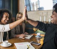 Two women giving each other a high five