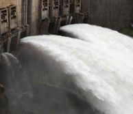 Close up of a dam with lots of water pouring through