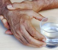 Hands holding a glass of water