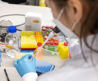 Researcher using pipette in the lab