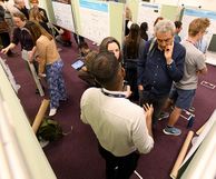 Group of people in discussion at a poster session