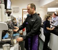 Barista making coffee in a cafe