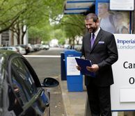 Security guard speaking with a driver at the car park