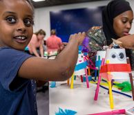 Child taking part in robot day at white city