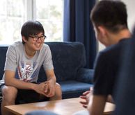 Students laughing while sitting on the sofa