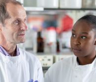 Robin Shattock in a lab with students