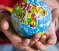 A child holding a model of the globe