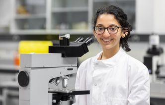 A student using a microscope in a laboratory