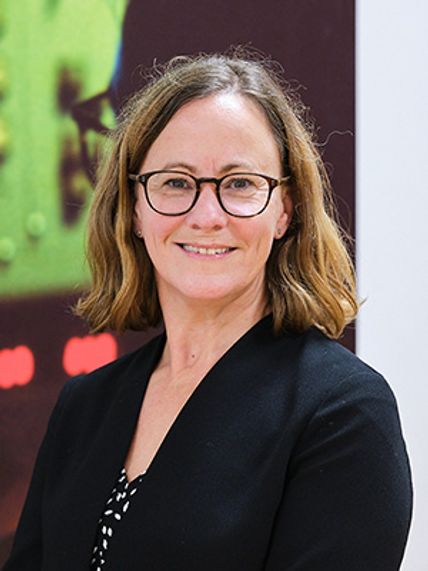 A portrait of a woman smiling at the camera