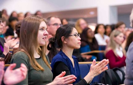 Female academics clapping