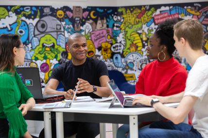 David Tyoember and others sitting at the Enterprise Lab