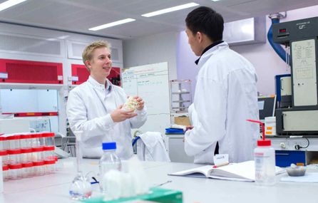 Two men speaking in a laboratory