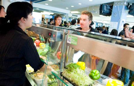 Woman serving food at catering outlet