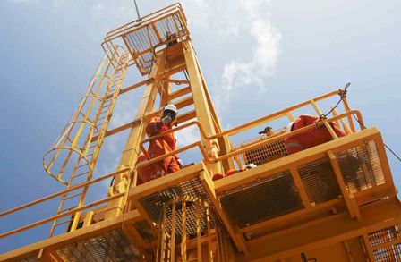 A yellow tower with a man in orange high vis