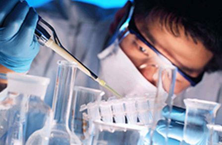 Man pipetting a liquid into containers