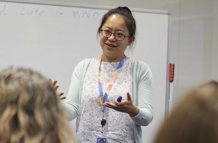 A woman presenting at a whiteboard