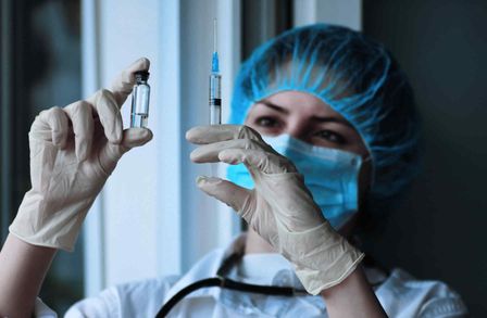 Doctor preparing to administer a vaccine