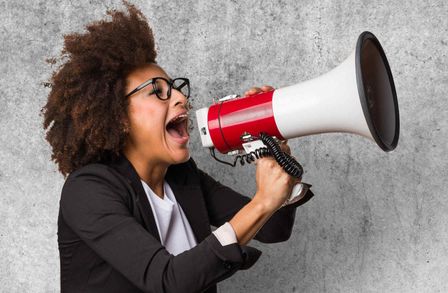 Woman shouting through a loud speaker