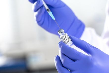 A scientist at Imperial College London draws the coronavirus vaccine into a syringe