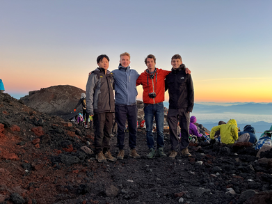 An image of four students on top of Mount Fuji, Japan