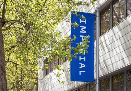 A blue Imperial banner hanging outside of a building on South Kensington campus