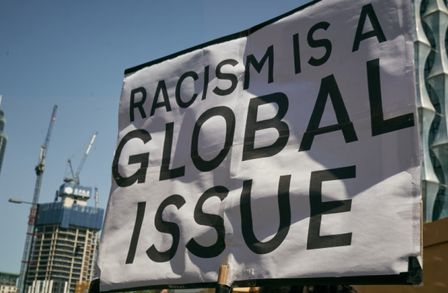 Banner saying 'racisim is a global issue'