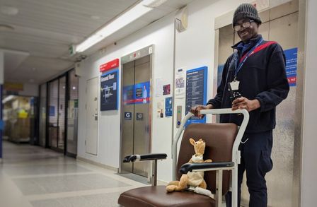 Man with a cuddly toy in a wheelchair in a hospital