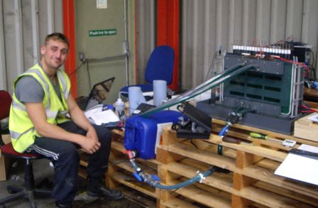 Student Tom sitting operating the pilot plant reactor