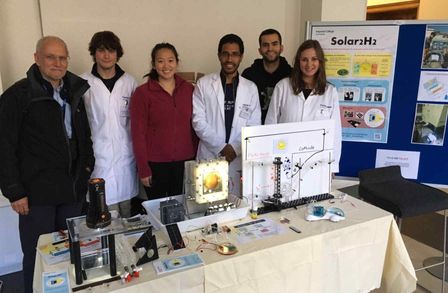 Photo showing members of the electrochemical engineering research group behind their outreach stall
